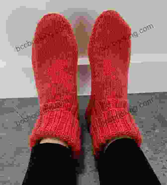 Image Of A Pair Of 8ply Striped Slipper Socks In Saffron Color, Knitted With A Textured Stitch Pattern And Vibrant Stripes. 8ply Striped Slipper Socks Knitting Pattern Saffron